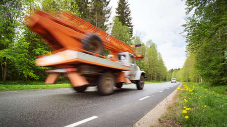 Car on asphalt road in beautiful spring dayの写真素材
