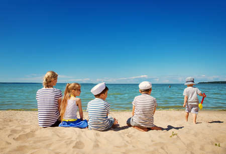 Babygirl and babyboy sitting on the beachの写真素材