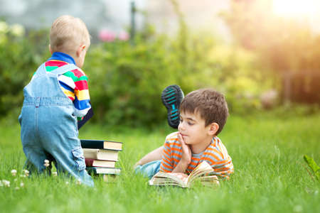 seven years old child reading a bookの写真素材