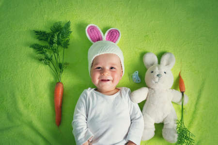 Cute baby lying on green towel.の写真素材