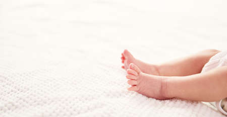 Cute newborn baby girl lying in the bedの写真素材