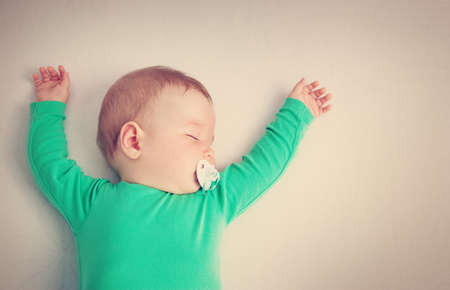 baby sleeping on the bedの写真素材