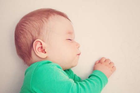 baby sleeping on the bed