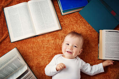 One year old baby with spectackles and books