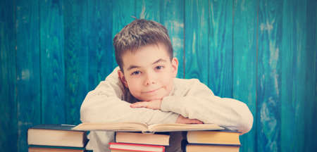 eight years old child reading a bookの写真素材