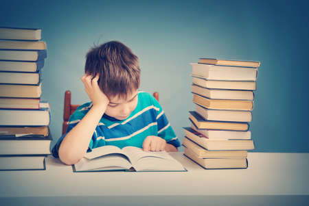 seven years old child reading a bookの写真素材