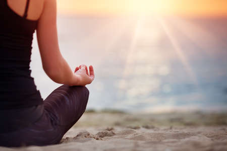 young woman sitting on the beachの写真素材