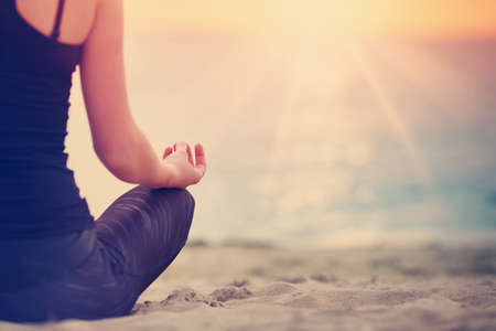 young woman sitting on the beachの写真素材