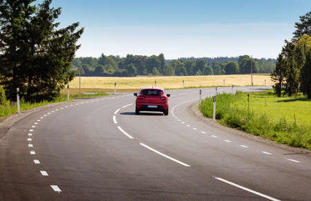 Car on asphalt road in beautiful spring day