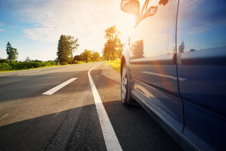 Car on asphalt road in summerの写真素材