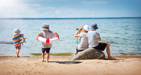 Babygirl and babyboy sitting on the beachの写真素材