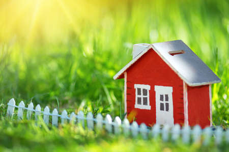 red wooden house on the grassの写真素材