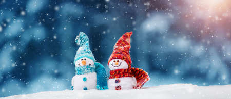 little snowmans on soft snow on blue backgroundの写真素材
