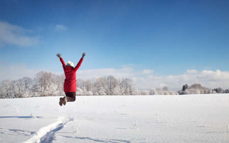 Happy woman in winter landscape on snowy landscapeの写真素材
