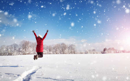 Happy woman in winter landscape on snowy landscapeの写真素材