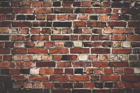 Old red brickwall texture with broken bricksの写真素材
