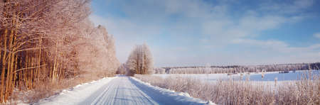 winter road, covered with snow on sunny dayの写真素材