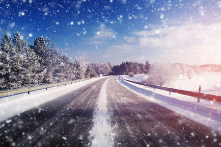 winter road, covered with snow on sunny dayの写真素材