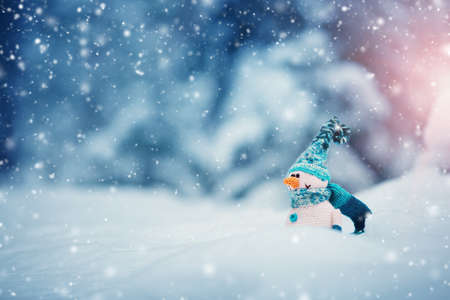 little snowmans on soft snow on blue backgroundの写真素材