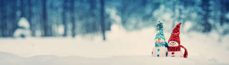 little snowmans on soft snow on blue backgroundの写真素材