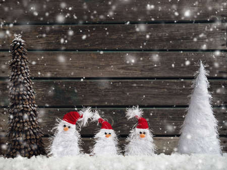 little snowmans on soft snow on rustic backgroundの写真素材