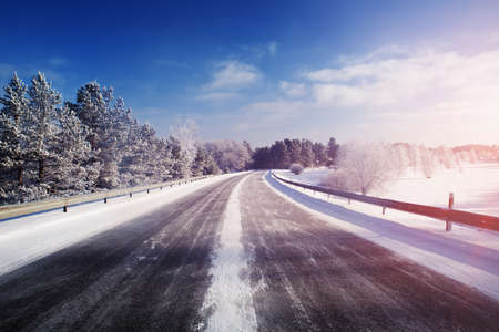 winter road, covered with snow on sunny dayの写真素材