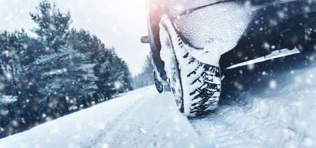 Closeup of car tires in winter on the roadの写真素材