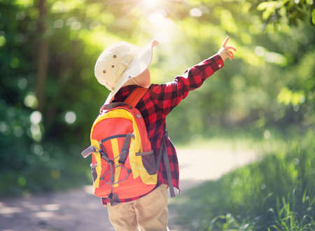 boy going camping with backpack in natureの写真素材