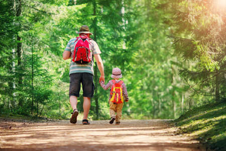 Father and boy going camping with tent in natureの写真素材