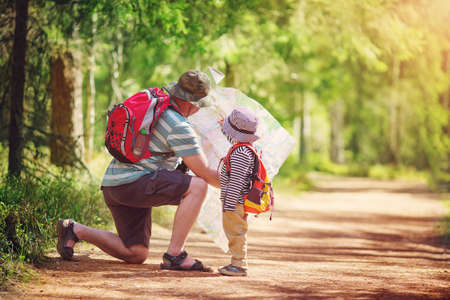 Father and boy going camping with tent in natureの写真素材