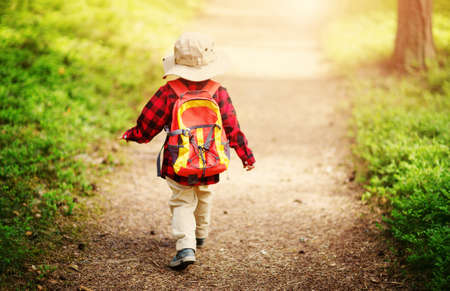 boy going camping with backpack in natureの写真素材