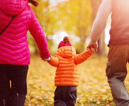 boy with mother and father holding hands on the natureの写真素材