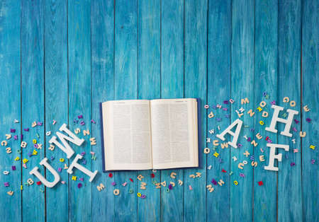 Open book on blue painted planksの写真素材