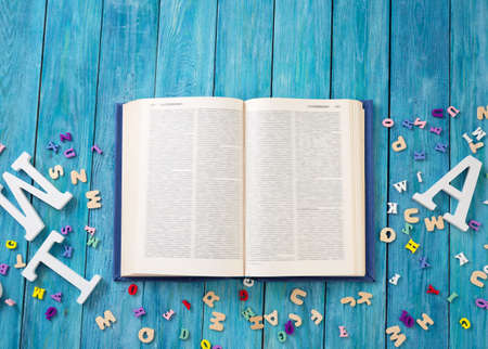 Open book on blue painted planksの写真素材
