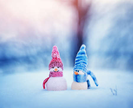 little snowmans on soft snow on blue backgroundの写真素材