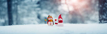 little snowmans on soft snow on blue backgroundの写真素材