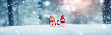 little snowmans on soft snow on blue backgroundの写真素材