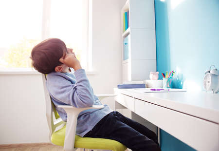 nine years old child writing at homeの写真素材