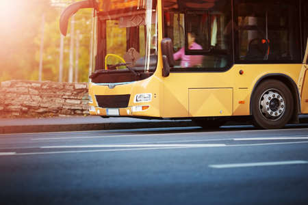 Bus moving on the road in city in early morningの素材 [FY310131649761]