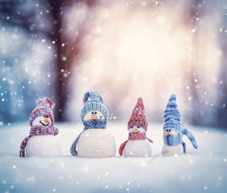 little snowmans on soft snow on blue backgroundの写真素材