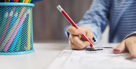 Little child at home drawing on the paperの写真素材