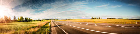 asphalt road panorama in countryside on sunny summer dayの写真素材