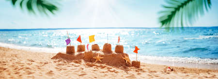 Sandcastle on the blue sea in summertimeの写真素材