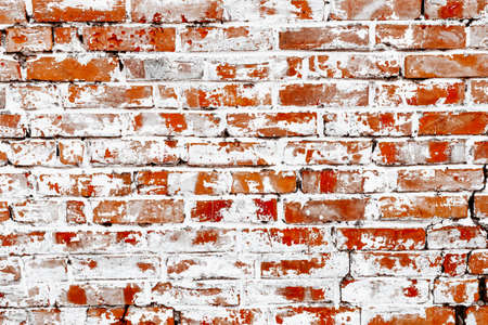 Rustic red brick background with white paintの写真素材