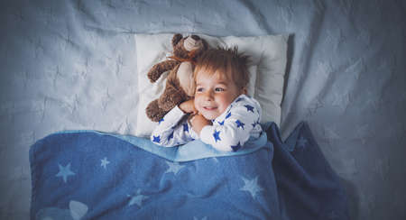 three years old child sleeping in bedの写真素材