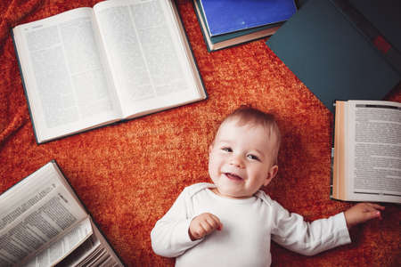 One year old baby with spectackles and booksの写真素材