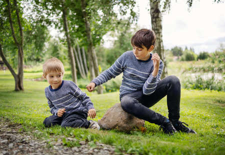 Two angry brothers fighting in park outdoorsの写真素材