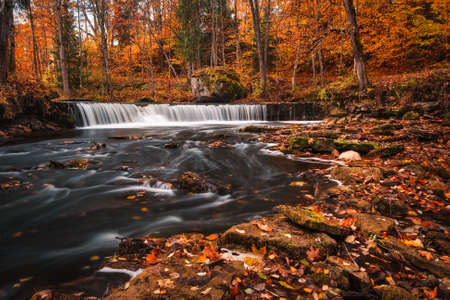 beautiful waterfall in autumn with blurred waterの写真素材