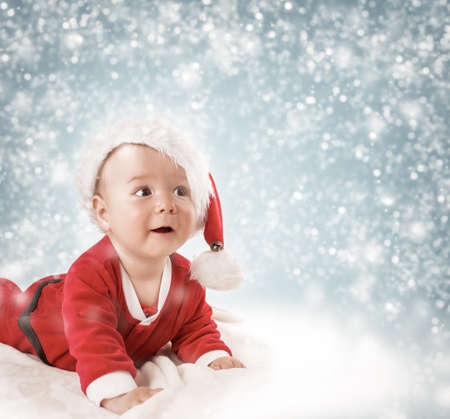 Eight month old baby lying on soft blanketの写真素材