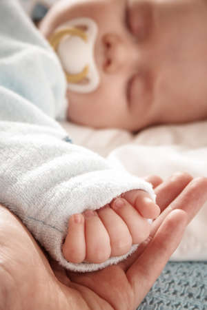 baby sleeping on blue blanketの写真素材
